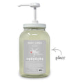 Glass body wash bottle with pump and 'plane products' label on a white background
