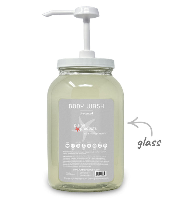 Glass body wash bottle with pump and 'plane products' label on a white background