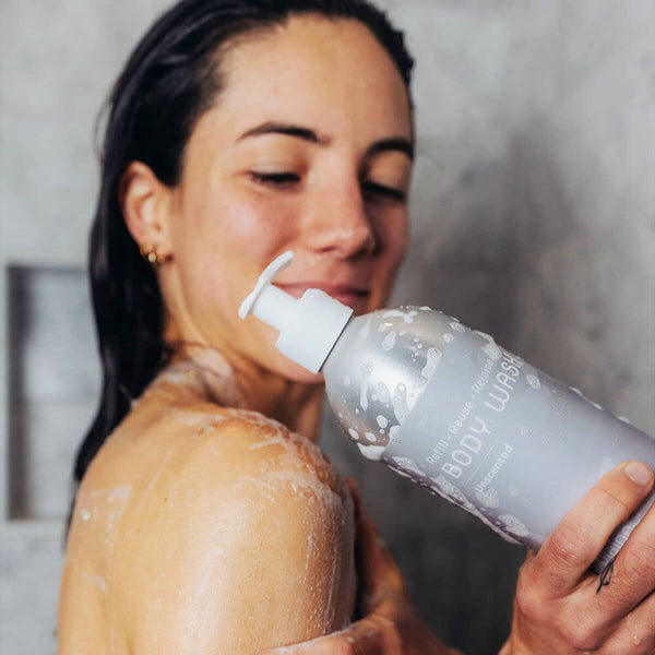 Unscented aloe body wash by Plaine Products displayed in natural bathroom environment