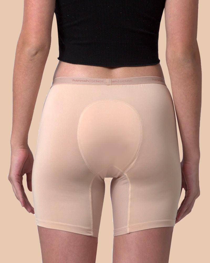 Beige shapewear shorts worn by a person on a beige background