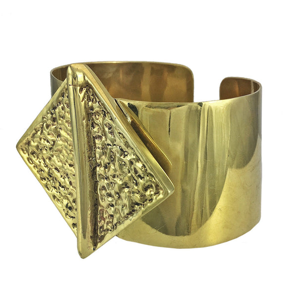 Close-up of polished brass hammered bombshell cuff bracelet, adjustable fit