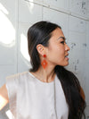 Bright orange fair trade resin dangle earrings by Fair Anita – front view