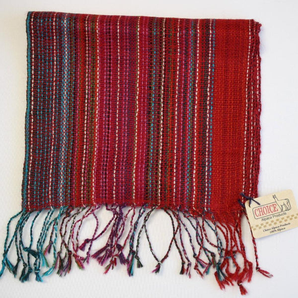 Red woven scarf with multicolored fringe on a white background, featuring a 'Choice' brand tag.