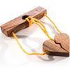 Wooden toy with a heart shape and yellow string on a white background