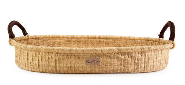 Woven basket with handles on a white background