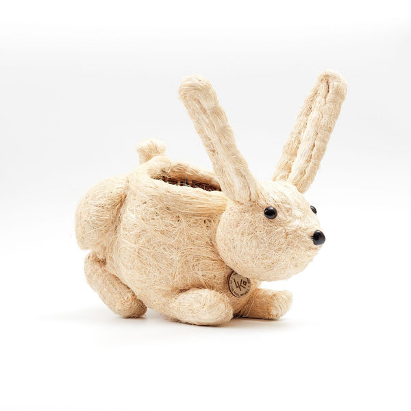 Beige rabbit-shaped plush toy on a white background