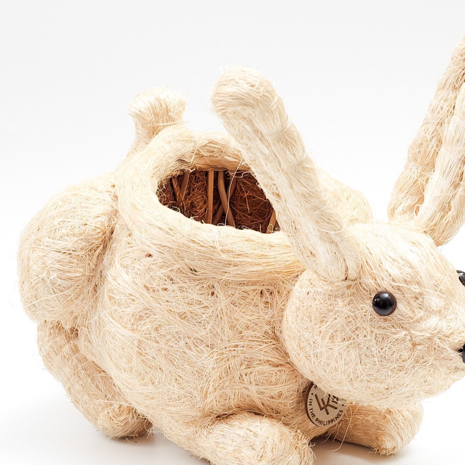Beige rabbit-shaped toy with a wooden block inside on a white background