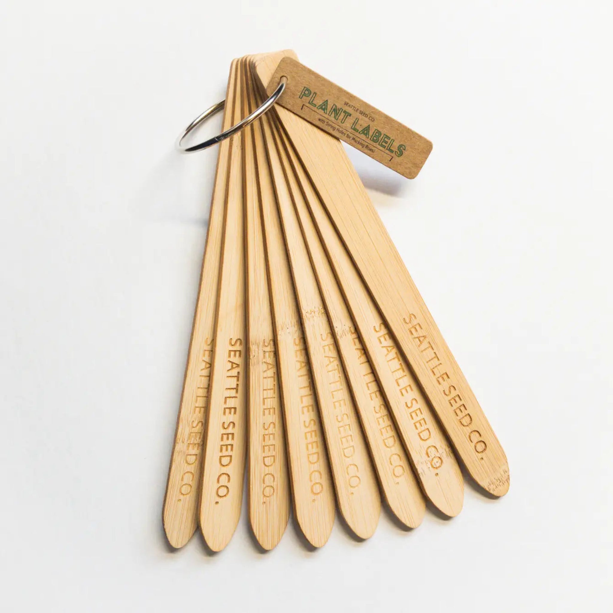Set of wooden plant labels with 'Seattle Seed Co.' branding on a white background
