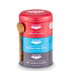 JusTea Black Tea Trio gift set with three stacking tins and hand-carved olive-wood spoons on a wooden surface