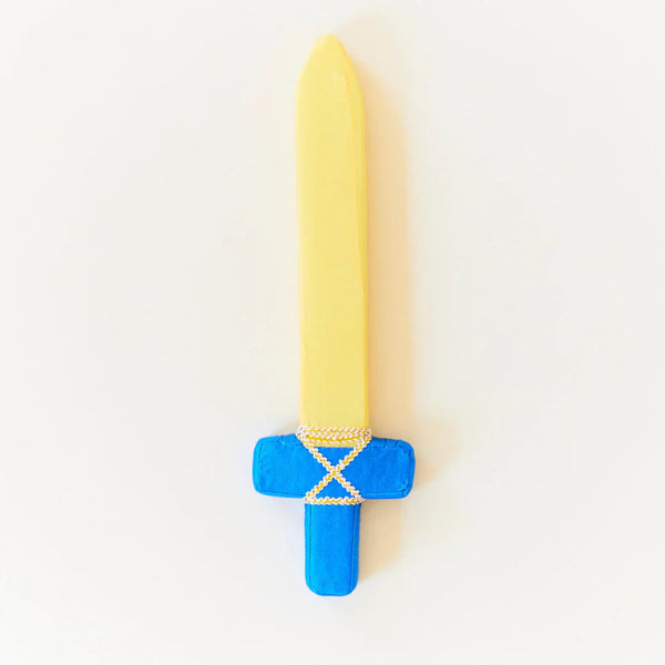 Toy sword with yellow blade and blue handle on a white background. Give the gift of imaginative play with our Sarah's Silks Blue Soft Sword. This silk play sword is a Christmas gift that encourages active play, creativity, and helps develop motor skills.