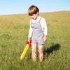 Child holding Sarah's Silks Red Soft Sword during pretend play and dress-up