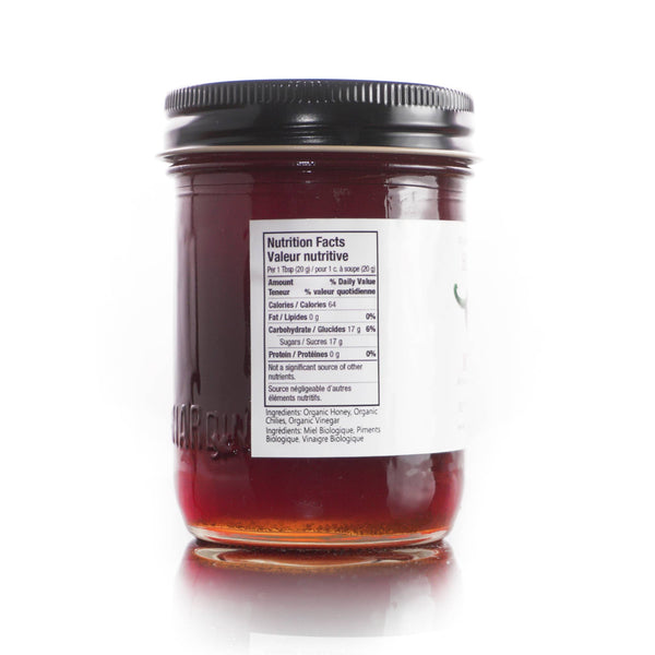 Jar of honey with a nutrition facts label on a white background
