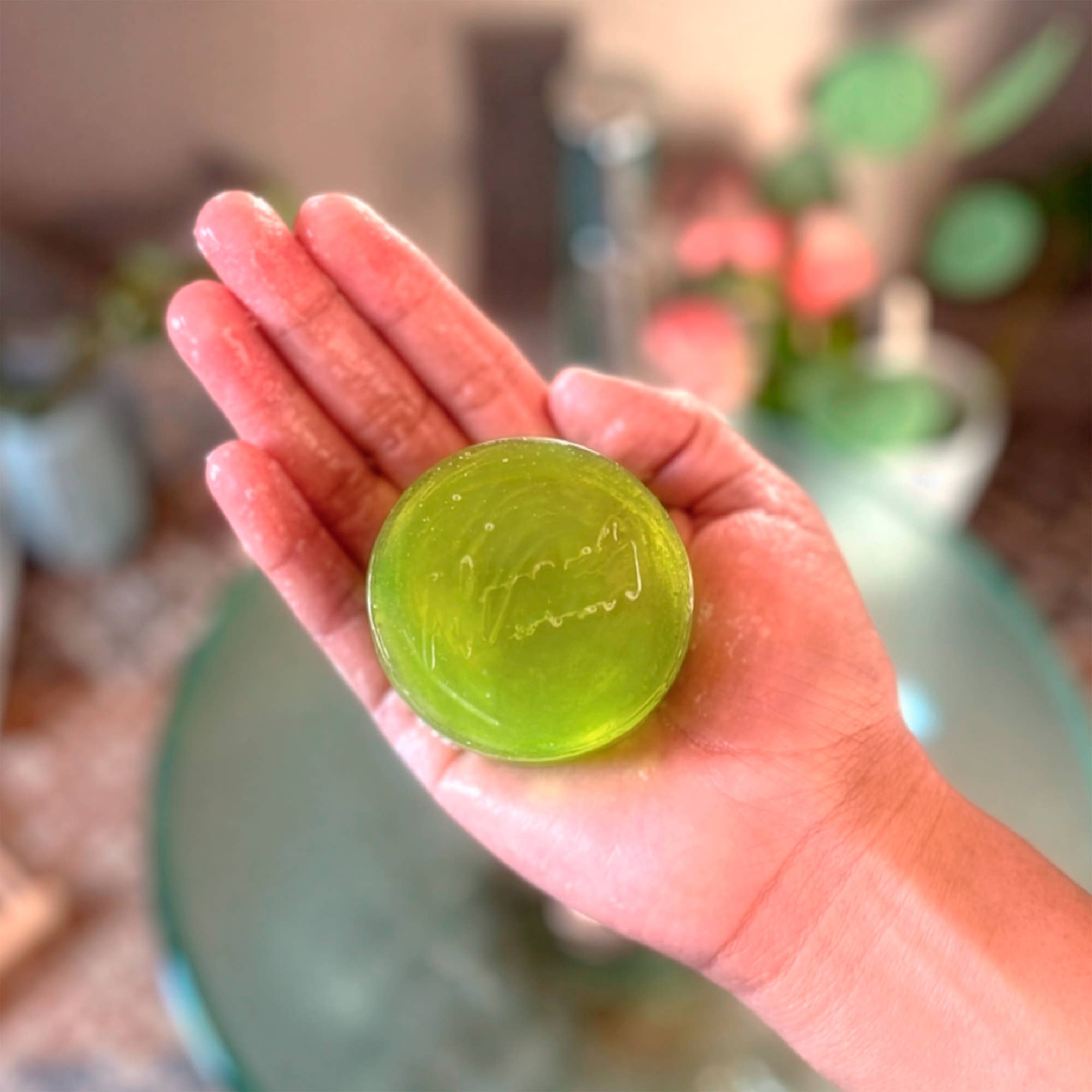 Hand holding a green soap bar with 'Green Soap' branding. NANAH Prickly Pear facial soap — nopal extract, hyaluronic acid, niacinamide & vitamin C for dry & combination skin. Balances pH & brightens. Plastic-free. Shop now.