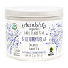 Close-up of Friendship Organics Blueberry Decaf Tea tin showing Fair Trade and Organic certifications
