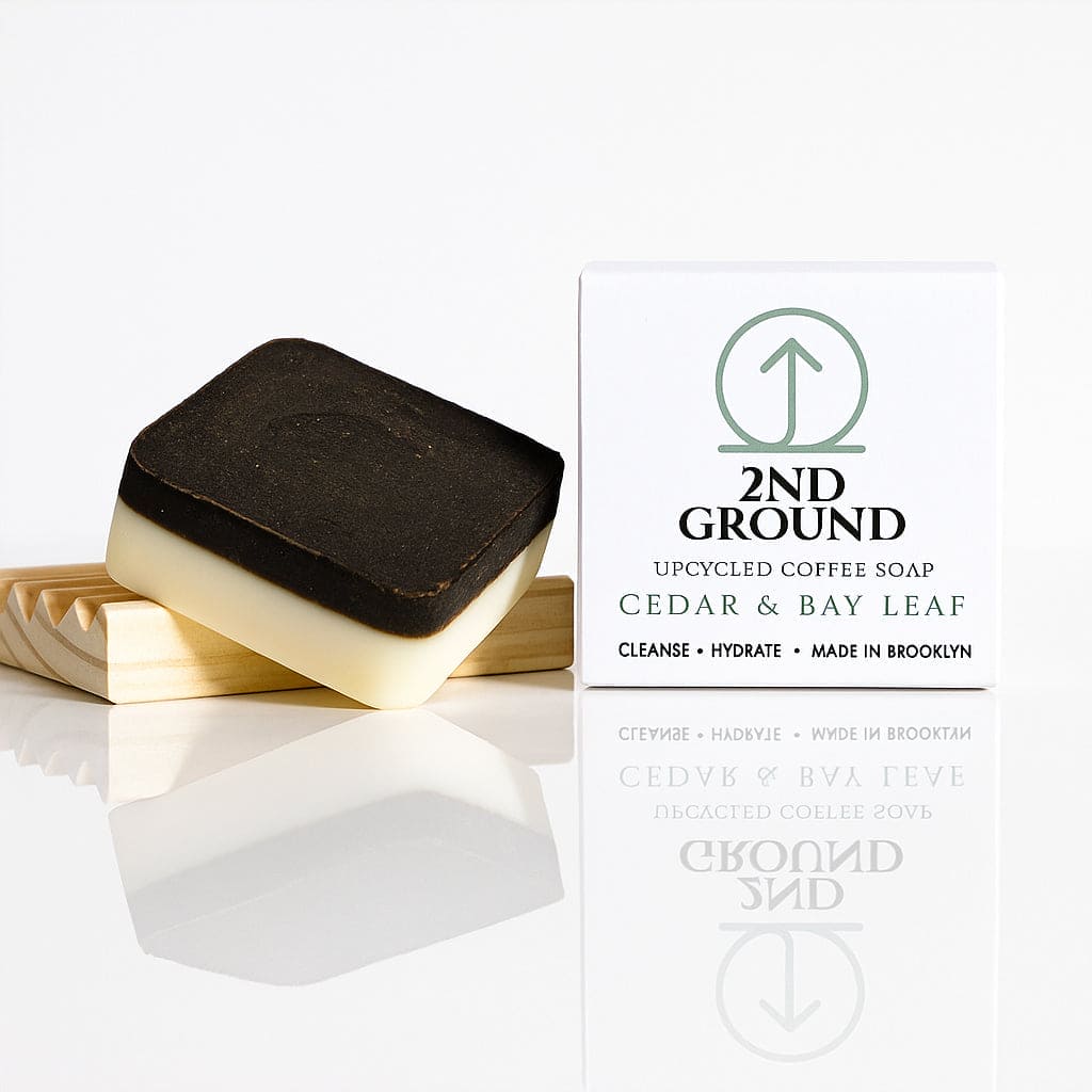 Two bars of soap with a packaging box labeled '2nd Ground' on a white background