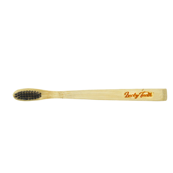 Bamboo toothbrush with black bristles on a white background