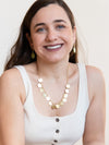 Close-up of Fair Anita disc charm necklace with large circular discs on recycled brass-plated chain