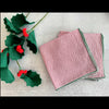 Red seersucker cocktail napkins with forest green edging, set of four, styled for a holiday table