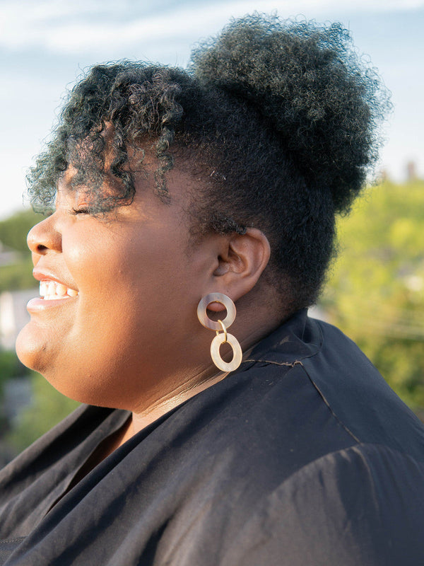 Fair Anita triple loop horn earrings styled on model showing dangle length and natural colour variation