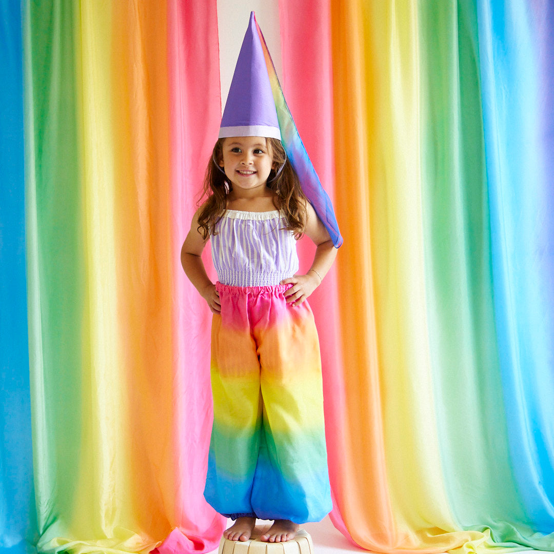 Unleash your child's inner jester with our Rainbow Jester Costume. This complete set includes a tunic, pants, and hat for endless fun and imaginative play. Perfect for parties, Halloween, and everyday adventures.