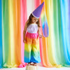 Unleash your child's inner jester with our Rainbow Jester Costume. This complete set includes a tunic, pants, and hat for endless fun and imaginative play. Perfect for parties, Halloween, and everyday adventures.