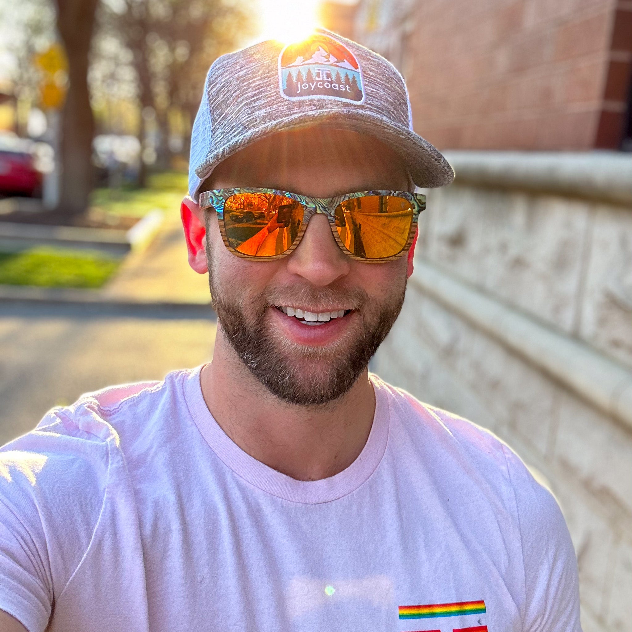 Joycoast Cirque Wayfinder abalone sunglasses with orange lens worn outdoors in natural light