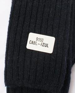 Black knit sweater with a label on a white background. Classic Alpaca Socks – soft, breathable, and versatile for year-round wear. Ethically made in Peru. Shop timeless alpaca comfort today.