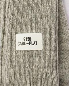 Label on a textured fabric with text '9150 CABL-PLAT'. Classic Alpaca Socks – soft, breathable, and versatile for year-round wear. Ethically made in Peru. Shop timeless alpaca comfort today.