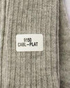 Label on a textured fabric with text '9150 CABL-PLAT'. Classic Alpaca Socks – soft, breathable, and versatile for year-round wear. Ethically made in Peru. Shop timeless alpaca comfort today.