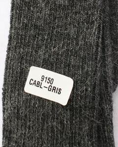 Textured dark fabric with a label reading '9150 CABL-GAIS'. Classic Alpaca Socks – soft, breathable, and versatile for year-round wear. Ethically made in Peru. Shop timeless alpaca comfort today.