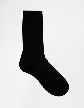 Black sock on a white background. Classic Alpaca Socks – soft, breathable, and versatile for year-round wear. Ethically made in Peru. Shop timeless alpaca comfort today.