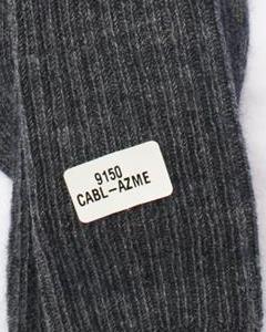 Text label on a textured gray fabric background. Classic Alpaca Socks – soft, breathable, and versatile for year-round wear. Ethically made in Peru. Shop timeless alpaca comfort today.