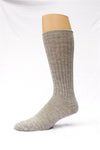 Gray knee-high sock on a mannequin leg against a white background. Classic Alpaca Socks – soft, breathable, and versatile for year-round wear. Ethically made in Peru. Shop timeless alpaca comfort today.