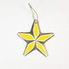 Close-up of handcrafted steel Christmas ornament made from recycled oil drum by Haitian artist Louis Omiscar
