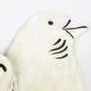 Upcycled steel Christmas tree ornaments from Haiti showing intricate hand-cut detailing on reindeer and snowflake designs