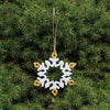 Decorative snowflake ornament hanging on a Christmas tree