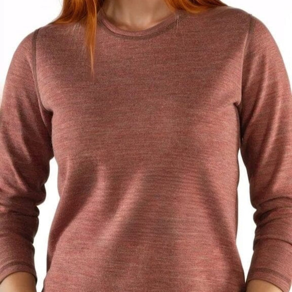 Woman wearing a pink long-sleeve shirt against a white background