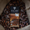 Pacari Cafe chocolate bar surrounded by cocoa beans in a burlap bag