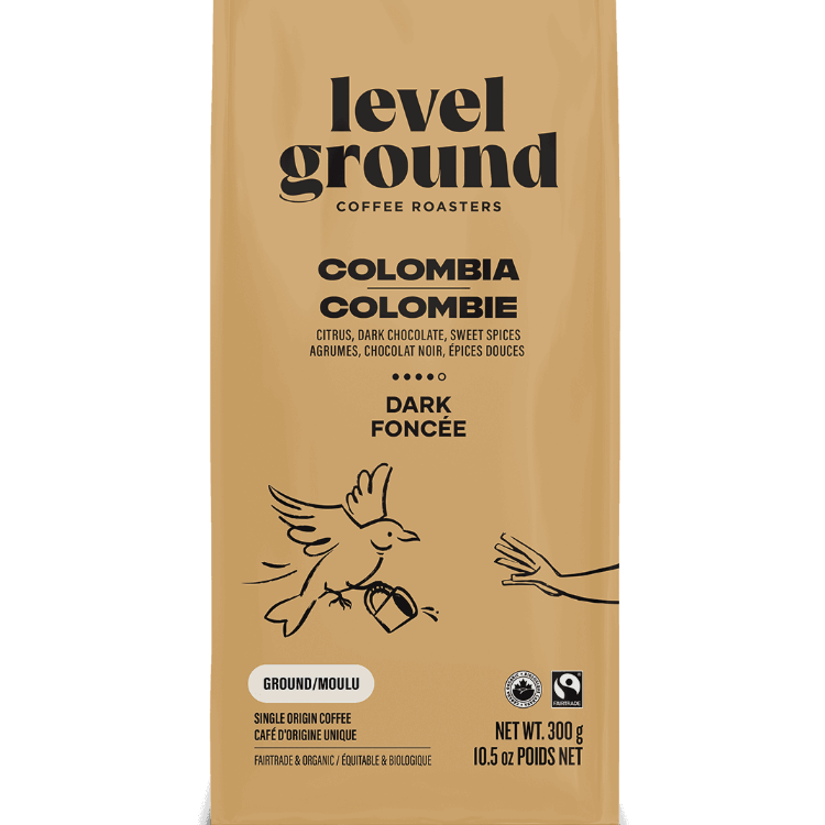 Close-up of Level Ground Colombian Dark Roast Coffee packaging showing tasting notes of citrus, dark chocolate, and sweet spice