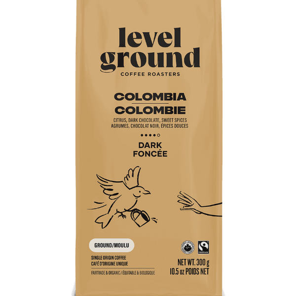 Close-up of Level Ground Colombian Dark Roast Coffee packaging showing tasting notes of citrus, dark chocolate, and sweet spice
