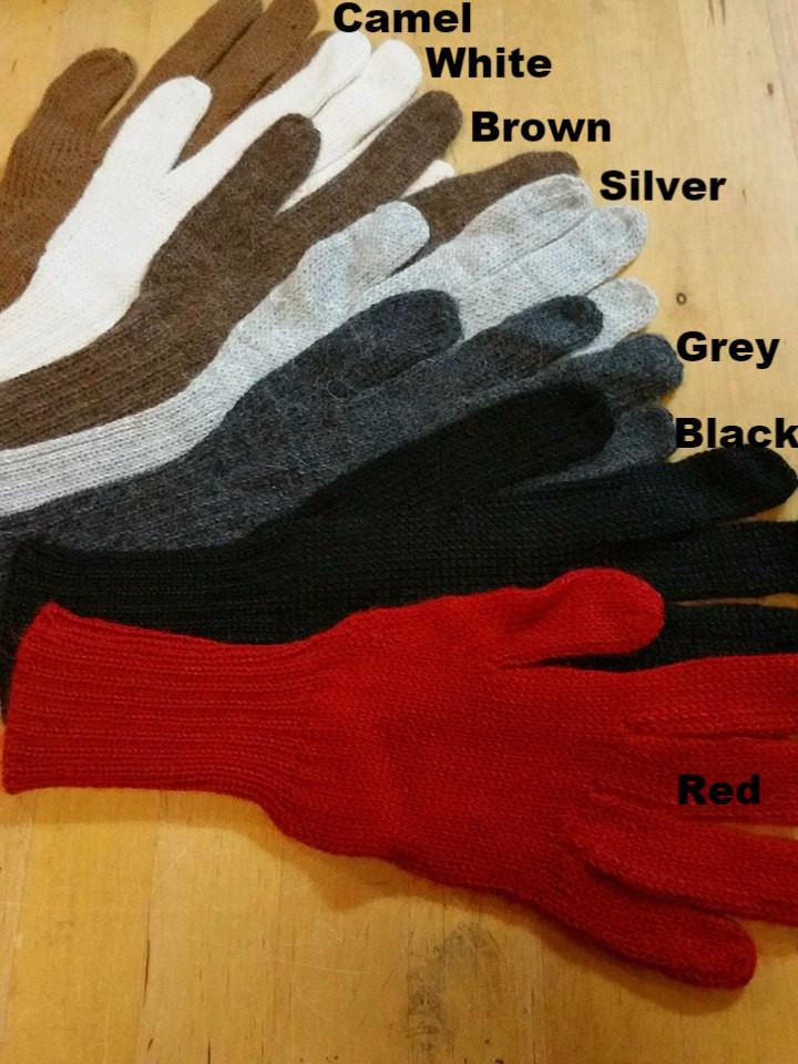 Set of gloves in various colors on a wooden surface