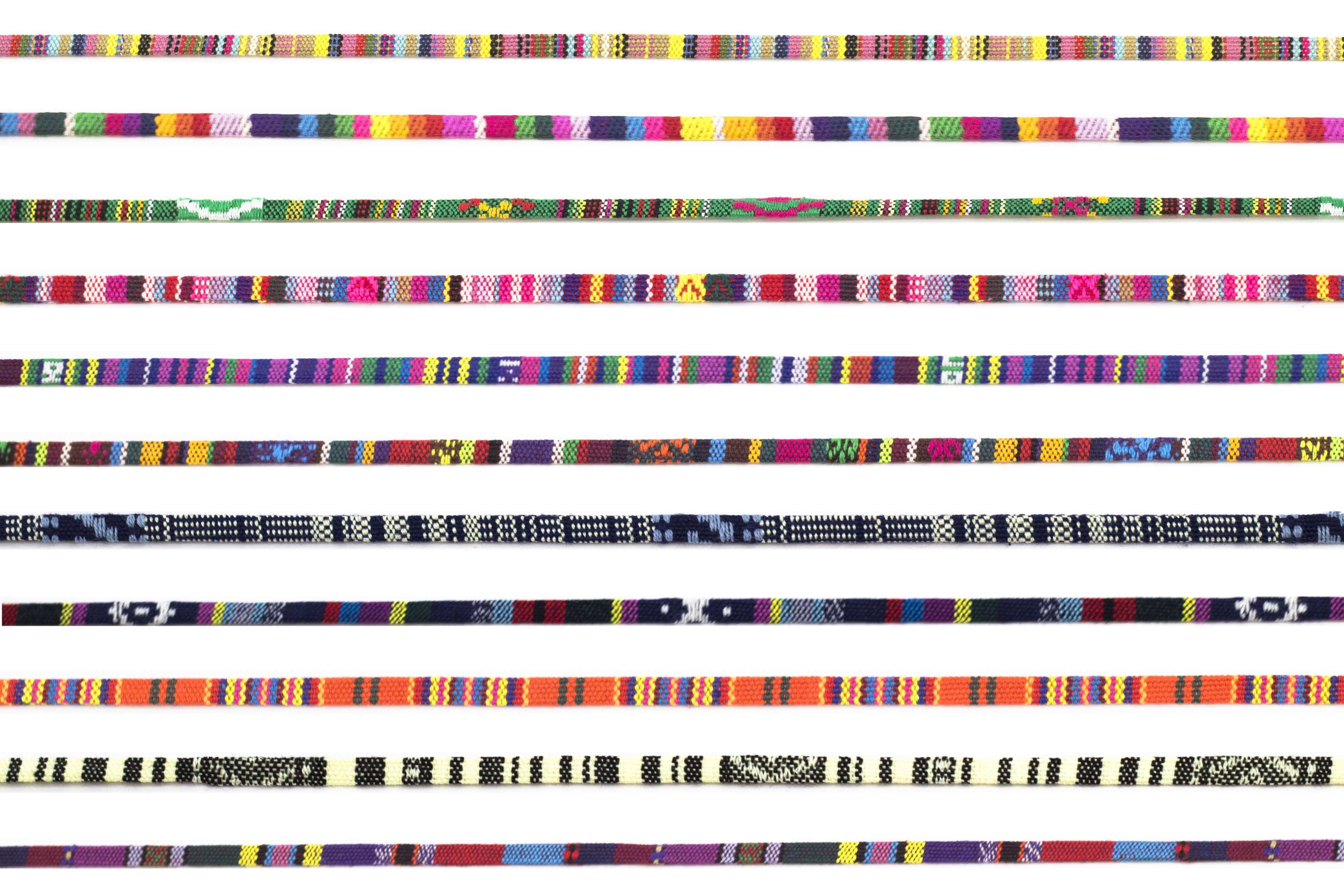 Collection of colorful woven bands with various patterns on a white background