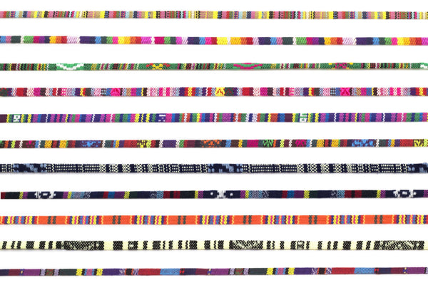 Collection of colorful woven bands with various patterns on a white background