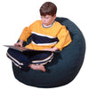Child sitting on a navy bean bag reading a book