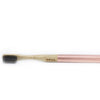 Bamboo toothbrush with rose gold handle on a white background
