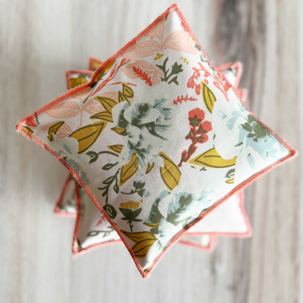 Dot and Army coral floral cotton lavender sachets placed on a surface, set of two handmade in Georgia