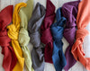 Set of four cotton crinkle cloth napkins in rainbow assorted colours by Dot and Army