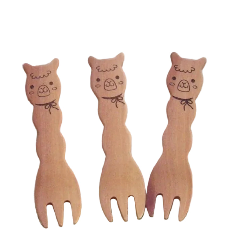 Set of three cute alpaca snack forks made from natural maple wood, laid out together