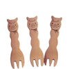 Set of three cute alpaca snack forks made from natural maple wood, laid out together