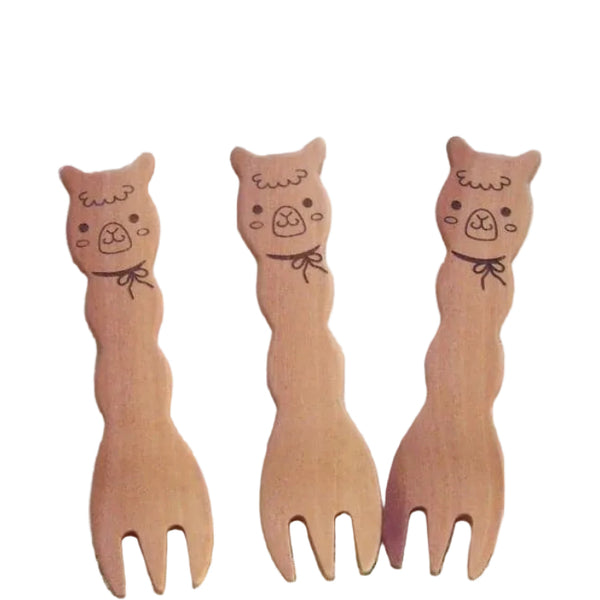 Set of three cute alpaca snack forks made from natural maple wood, laid out together